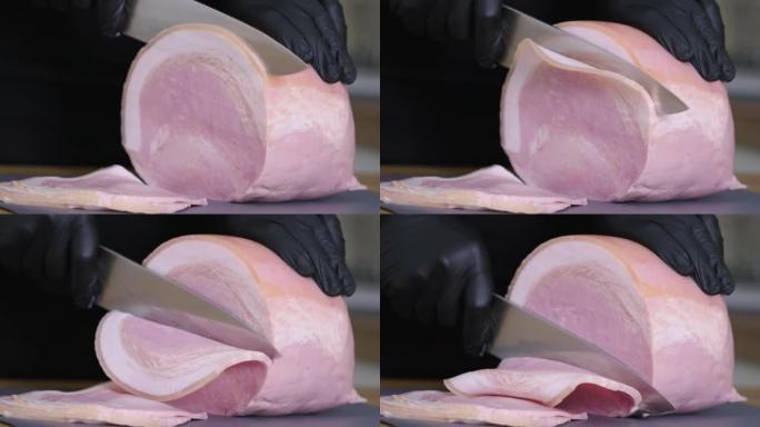 猪油熏火腿。用刀将传统火腿在砧板上切成碎片。薄片肉。美食小吃和烹饪的概念。持刀男子正在切西班牙猪腿火