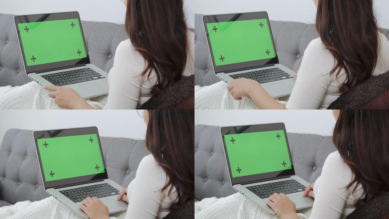 女人使用笔记本电脑，如视频通话和搜索信息，绿屏与标记点。