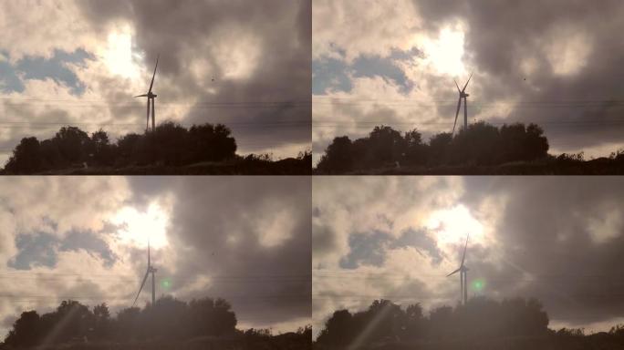 风力涡轮机在戏剧性的天空中旋转