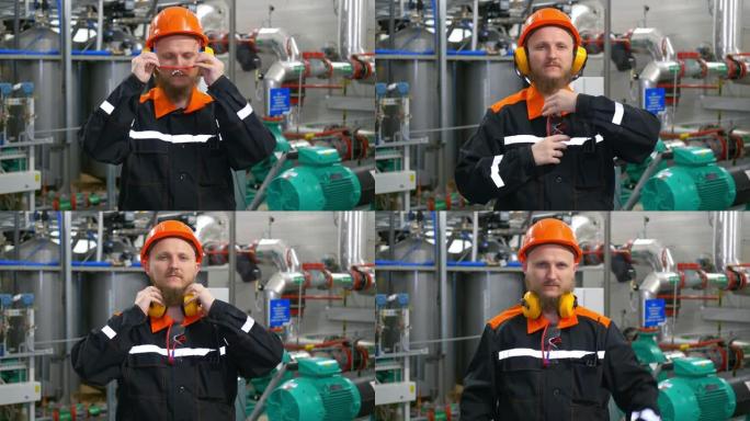 工业操作员男子戴着橙色头盔，戴着耳机和眼镜，在西伯利亚一个油田抽油和天然气的车间工作场所。石油和天然