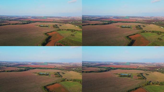 乌克兰的田野在定居点附近的山丘上延伸鸟瞰图