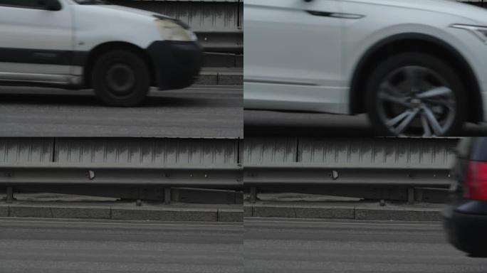 汽车行驶的城市道路的近景。移动的运输工具滚动的轮子，慢镜头200帧/秒