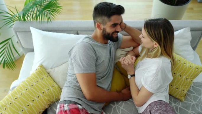 Young couple relaxing in bed.