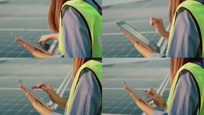 使用笔记本电脑检查太阳能电池板的亚洲女技术员的特写。