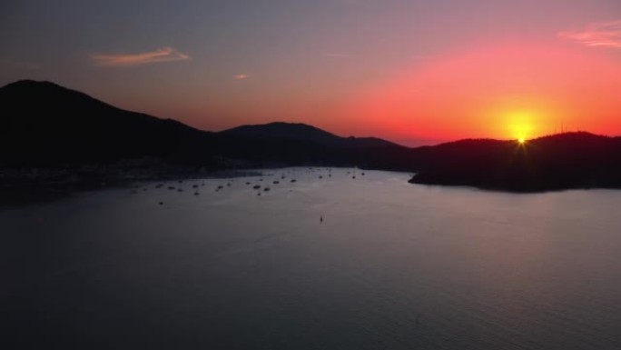 Seascape with amazing orange pink sunset over moun