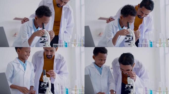 4k，男生在显微镜下与亚洲男老师一起学习，他在小学实验教室里有兴趣和专心地教授科学入门课程。