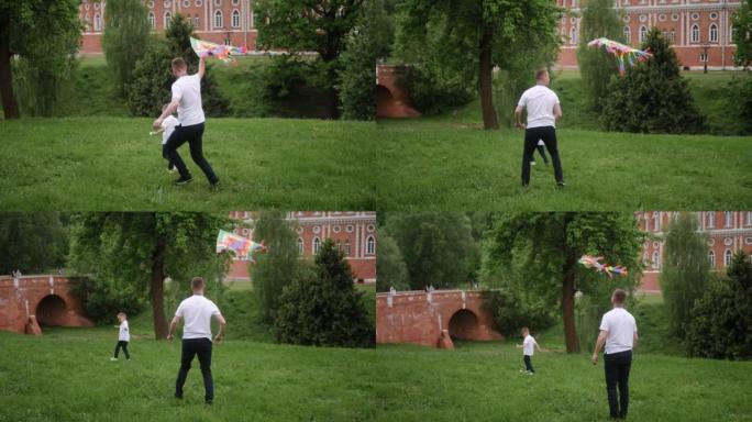 男子在绿地上的公园里放风筝，一家人追赶他