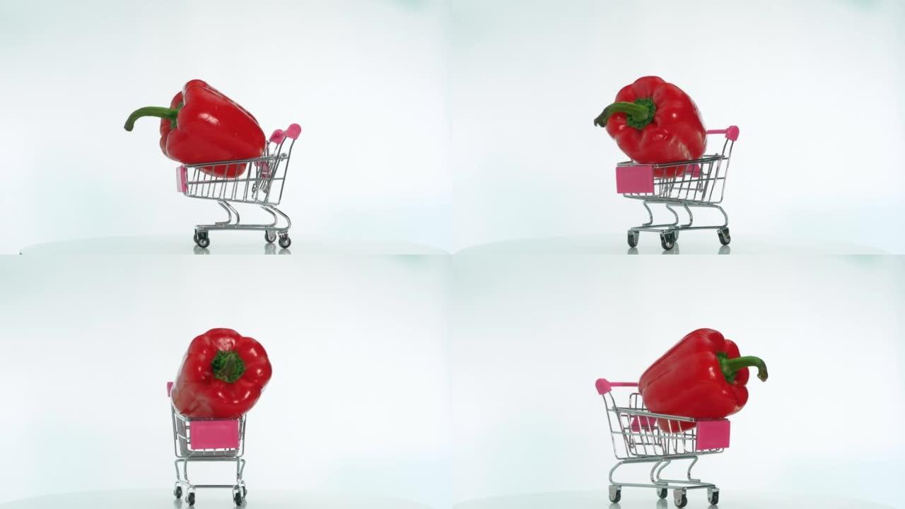 超市手推车里的天然蔬菜甜椒在旋转的桌子上旋转，开胃的红辣椒在白色背景的桌子上旋转