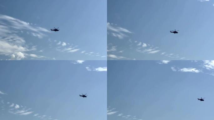 军用直升机在蓝天白云中飞行