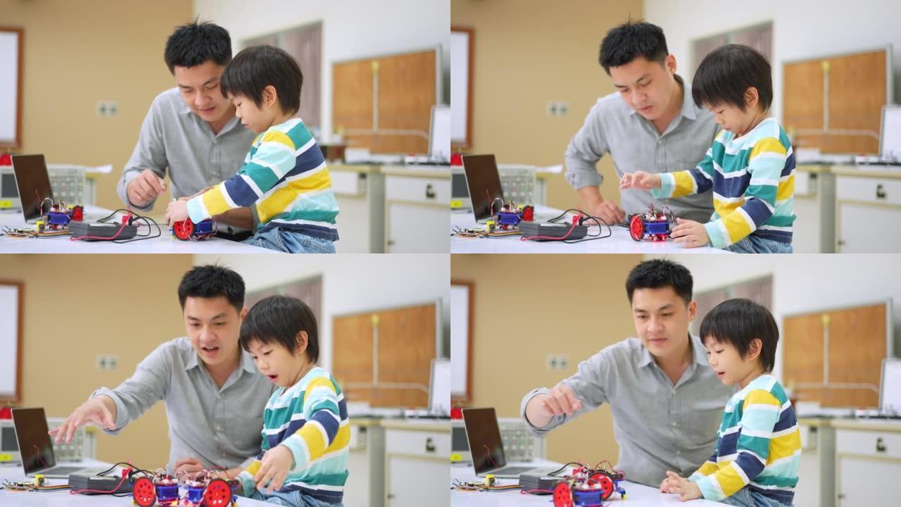 亚洲学生和老师使用电子仪表和笔记本电脑在科学课中构建自主自驱动机器人汽车的原型