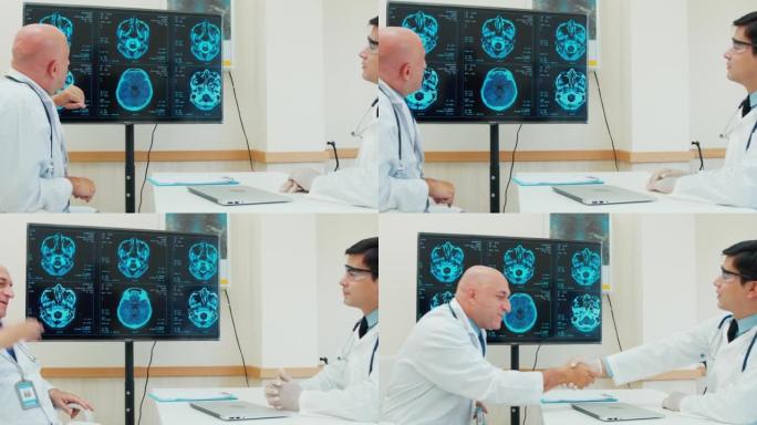 两名白人男性医生在监视器电脑屏幕上分析和讨论的4k镜头。他们在医疗中心聊天。