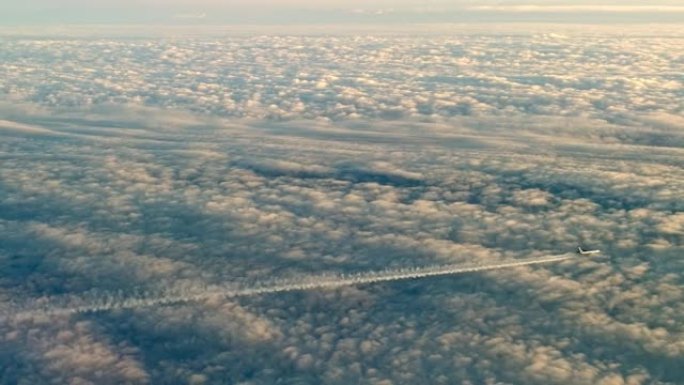 喷气式飞机飞过云层，留下凝结的空气轨迹。鸟瞰图