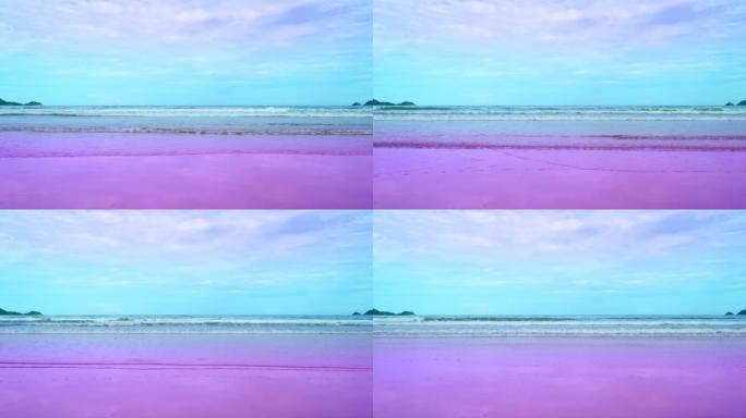 惊人的夏季海洋背景。海浪在粉红色的沙滩上破裂海浪撞击空旷的海滩。海浪和美丽的柔和色彩浪漫的沙滩渐变色