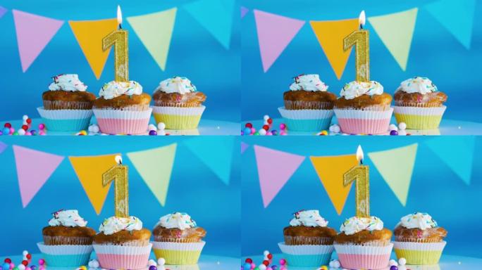 美丽的生日祝福给一个1岁的孩子在蓝色的背景。有蜡烛和生日装饰的节日生日奶油蛋糕