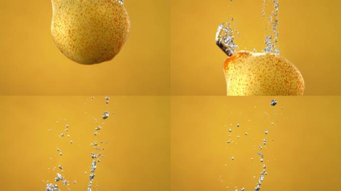 梨掉入水中并在黄色背景上慢动作产生气泡
