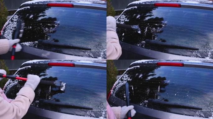 特写女人用汽车雪刷和刮冰器清除汽车后窗积雪