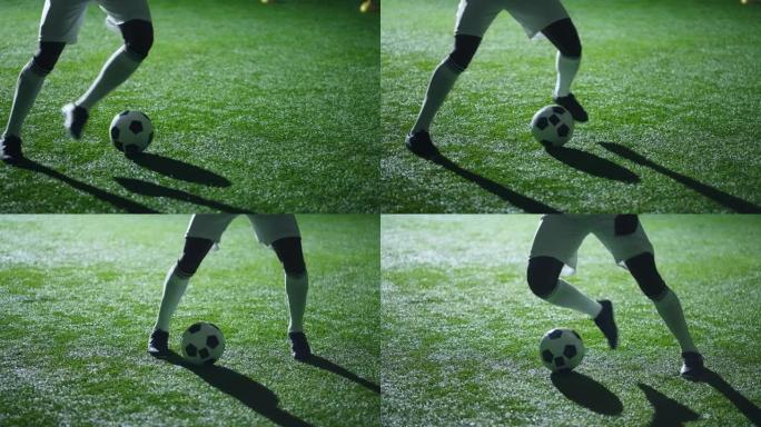 足球运动员的腿在训练过程中带球，特写镜头，穿着靴子和绑腿的男性脚