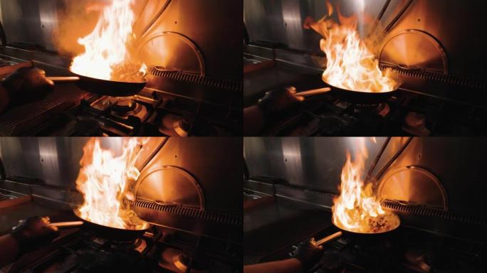 在煎锅里煮炸薯条蔬菜。飞行蔬菜。用火和煤做饭。慢动作