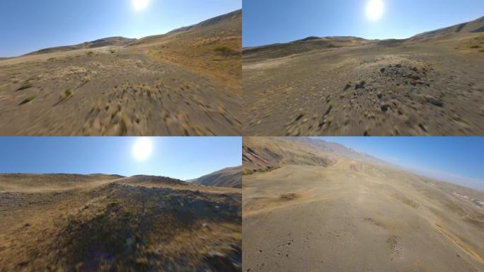 FPV运动无人机拍摄阳光全景丘陵沙漠地形黄色干燥结构阳光蓝天