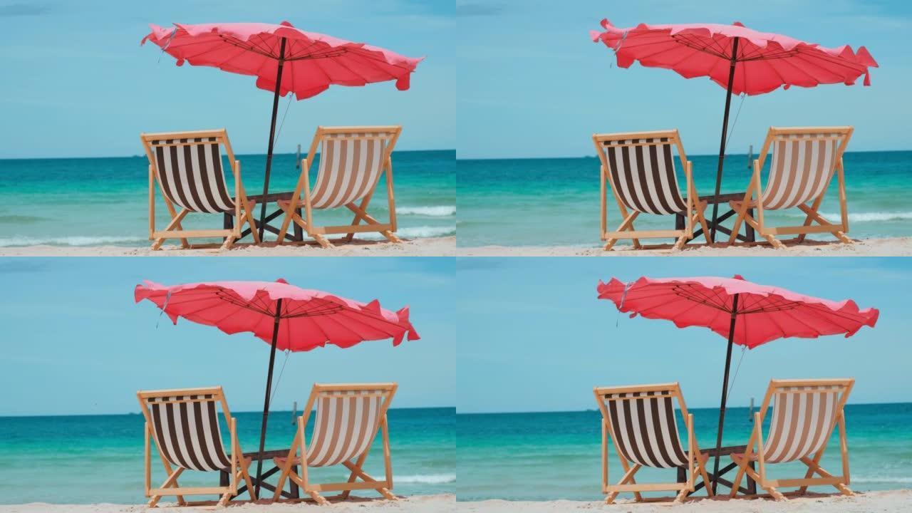 女孩坐在海边沙滩上的沙滩椅上，手里拿着手机日落时的女孩