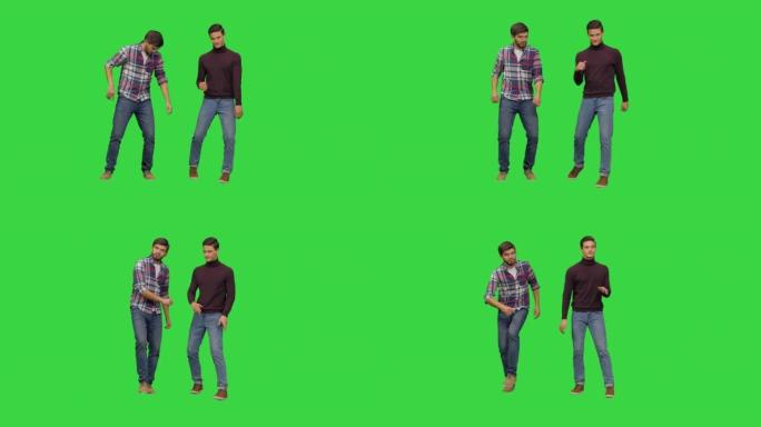 两个年轻人在绿色屏幕上以有趣的尴尬方式跳舞，色键