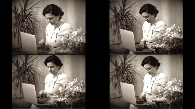 一个女人使用笔记本电脑的老式20世纪20年代电影。