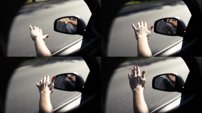 女孩把手伸出车窗。出城旅行