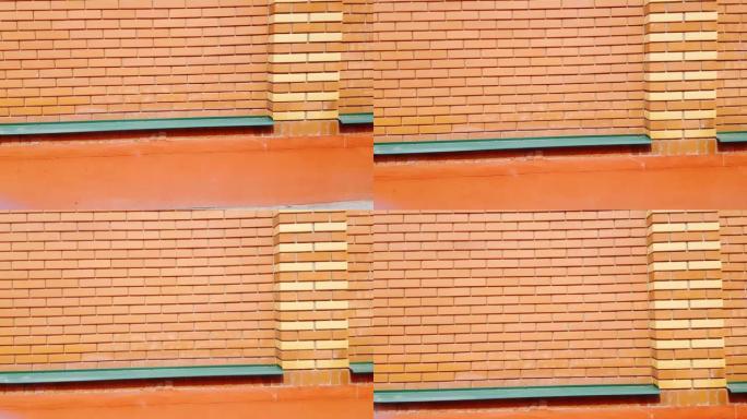 摄像机缓慢移动砖墙，现代砖石，新橙色砖，户外，4k