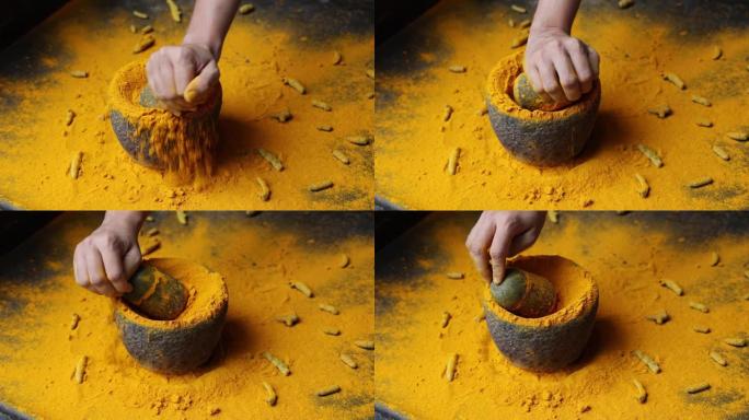 女人手粉化印度香料姜黄粉石砂浆喀拉拉邦印度