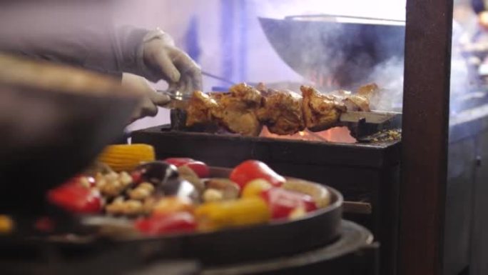 关闭烹饪街头食物。多汁的烤肉串和在烤架上用煤油炸的蔬菜。野餐或晚上烧烤。冬季交易会，户外贸易。