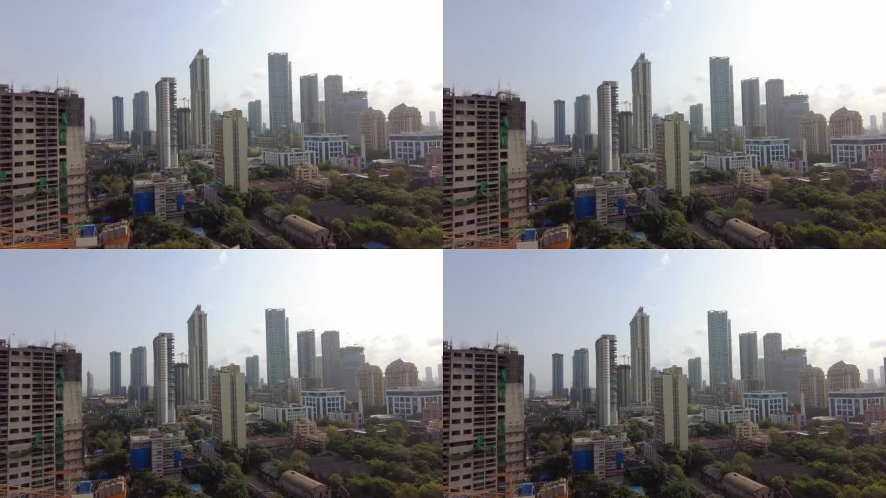 印度孟买市的空中平移镜头。风景秀丽的天际线在戏剧性的天空和阳光下。