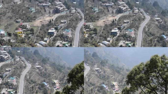 在印度北阿坎德邦奈尼塔尔 (Nainital) 的山区道路上行驶的交通车辆的俯视图，从山顶观看交通车