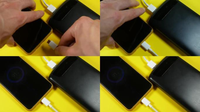 带usb的黑色电源正在为黄色背景的智能手机充电。