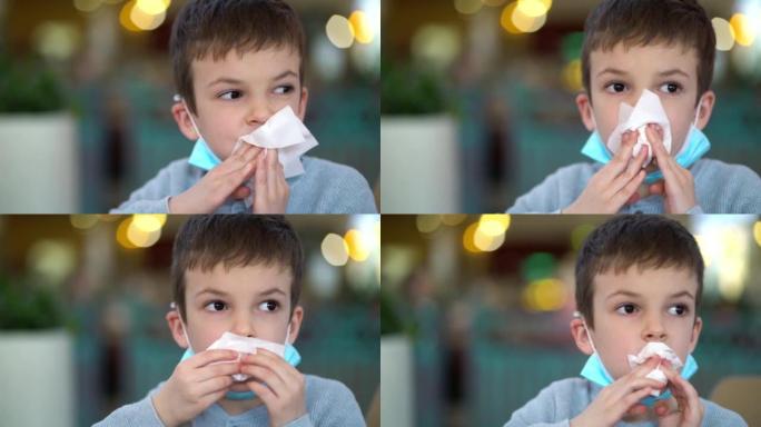 蒙面男孩在餐厅用餐巾擦嘴的画像。
