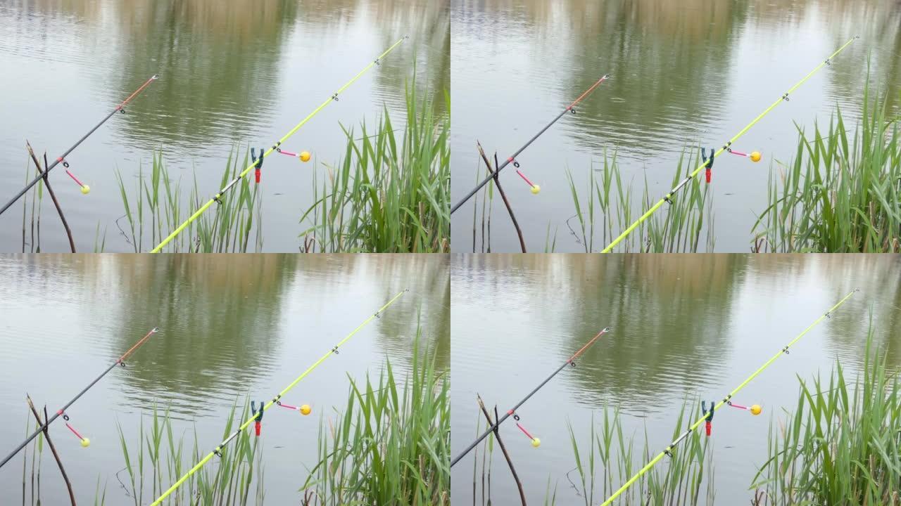 钓鱼时，将彩色的拨浪鼓放在钓鱼竿上。杆尖端的咬合信号。叮咬警报会提醒你被咬。渔具特写。
