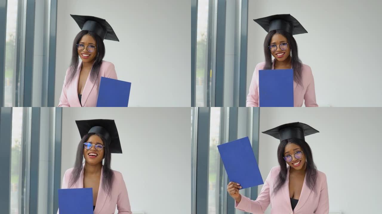 一位穿着浅粉色经典西装，戴着方形大师帽子的非裔美国女毕业生手持文凭，摆姿势，兴致勃勃地跳舞。国外妇女