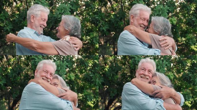 可爱的老夫妇拥抱在户外一起玩乐。爱和感情概念。男人和女人拥抱。