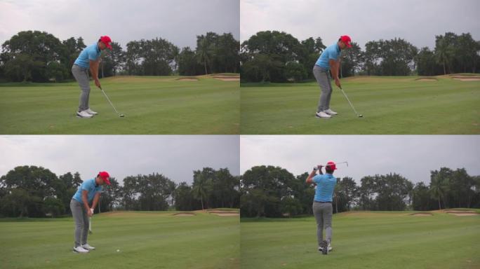 一名亚洲职业男子高尔夫球手在高尔夫球场上进行发球射击的镜头。