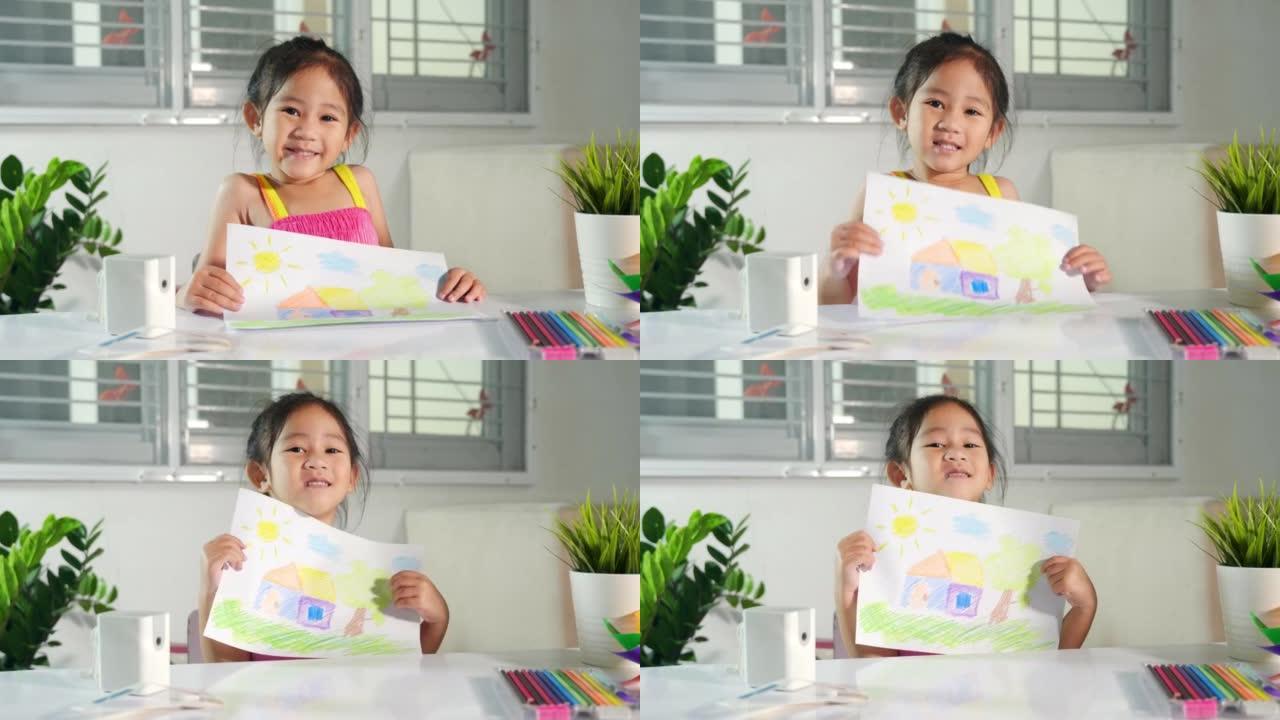 小女孩举起五颜六色的绘画风景我的家庭梦想在纸上相机