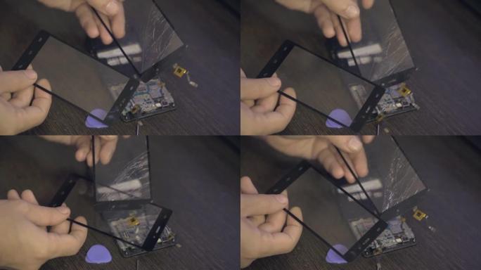 手机维修，一名男子拆开智能手机的机身。