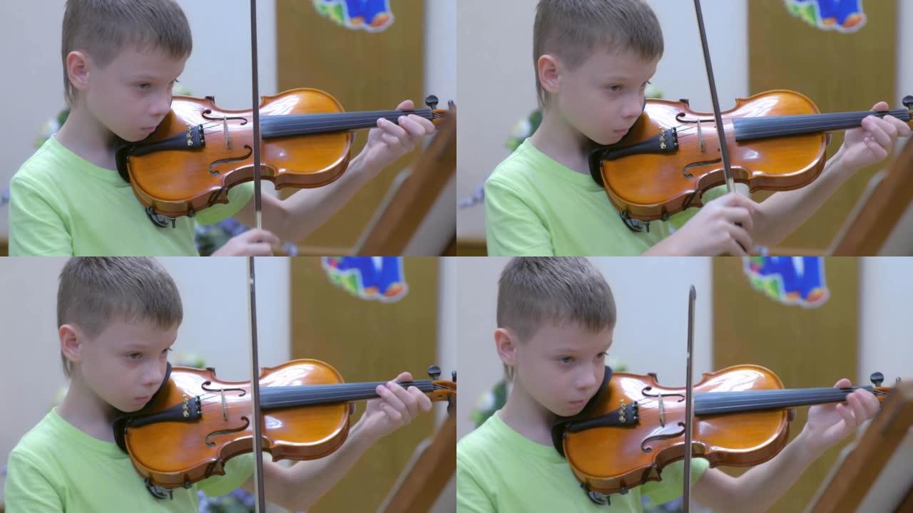 十几岁的男孩在学校的音乐课上练习拉小提琴。