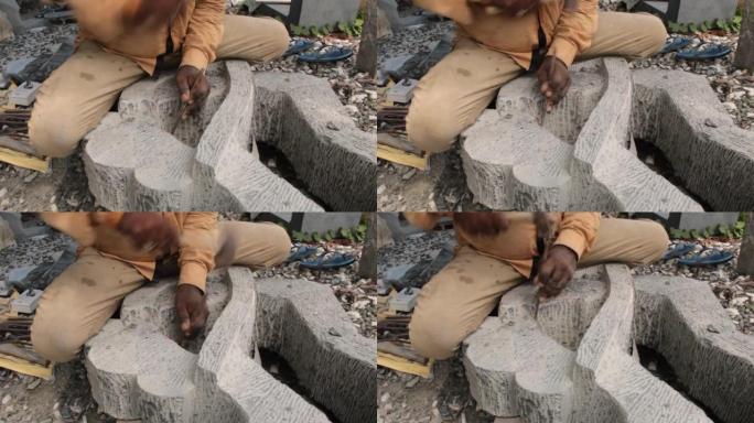 印度石雕艺术家用黑色花岗岩雕刻一个美丽的抽象雕塑，