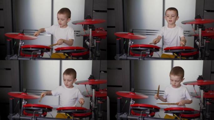 一个男孩在家玩电子鼓。一个小男孩喜欢在家玩电子鼓，红色鼓。在家隔离的男孩练习鼓