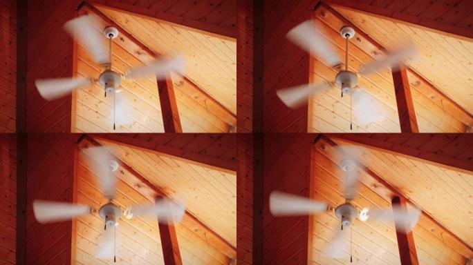 天花板上的吊灯风扇。风扇吊灯在木制天花板上运行。带风扇旋转的吊灯。木制天花板