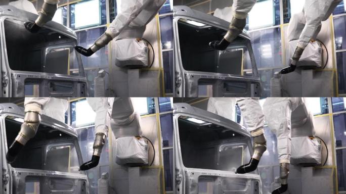 机器人技术油漆车身。景。机器人手油漆车身。在生产中使用机器人机器涂漆车