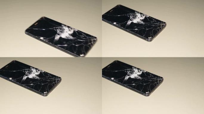 一部坏掉的智能手机掉下来的超慢镜头。小玩意的玻璃有裂纹。了电话。
