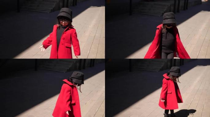 穿着红色外套的时尚韩国女婴在春天走在街上