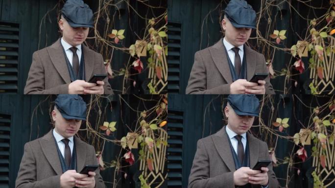 年轻时尚的商人在街上使用智能手机。一个英俊男子在户外打电话的肖像