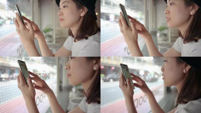 年轻的泰国亚洲女性周末在咖啡馆使用智能手机拍照焦糖拿铁咖啡放松，并将照片按摩上传到社交网络