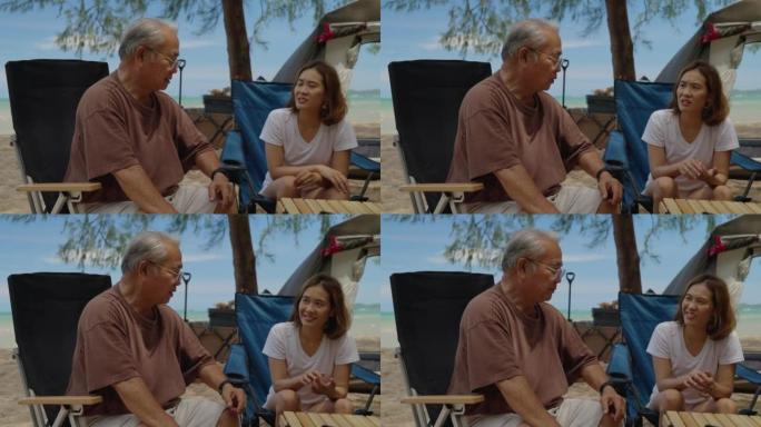 老人在海滩上旅行的肖像，积极的祖父与家人一起度假，快乐的叔叔坐在露营的桌椅上在海上放松